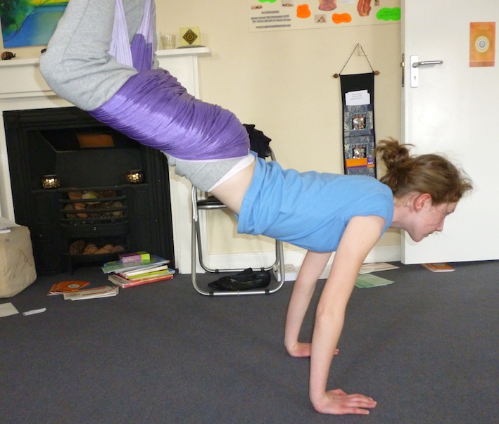 A visitor shows what she can do on the swing at Yoga Glow Studio Beccles